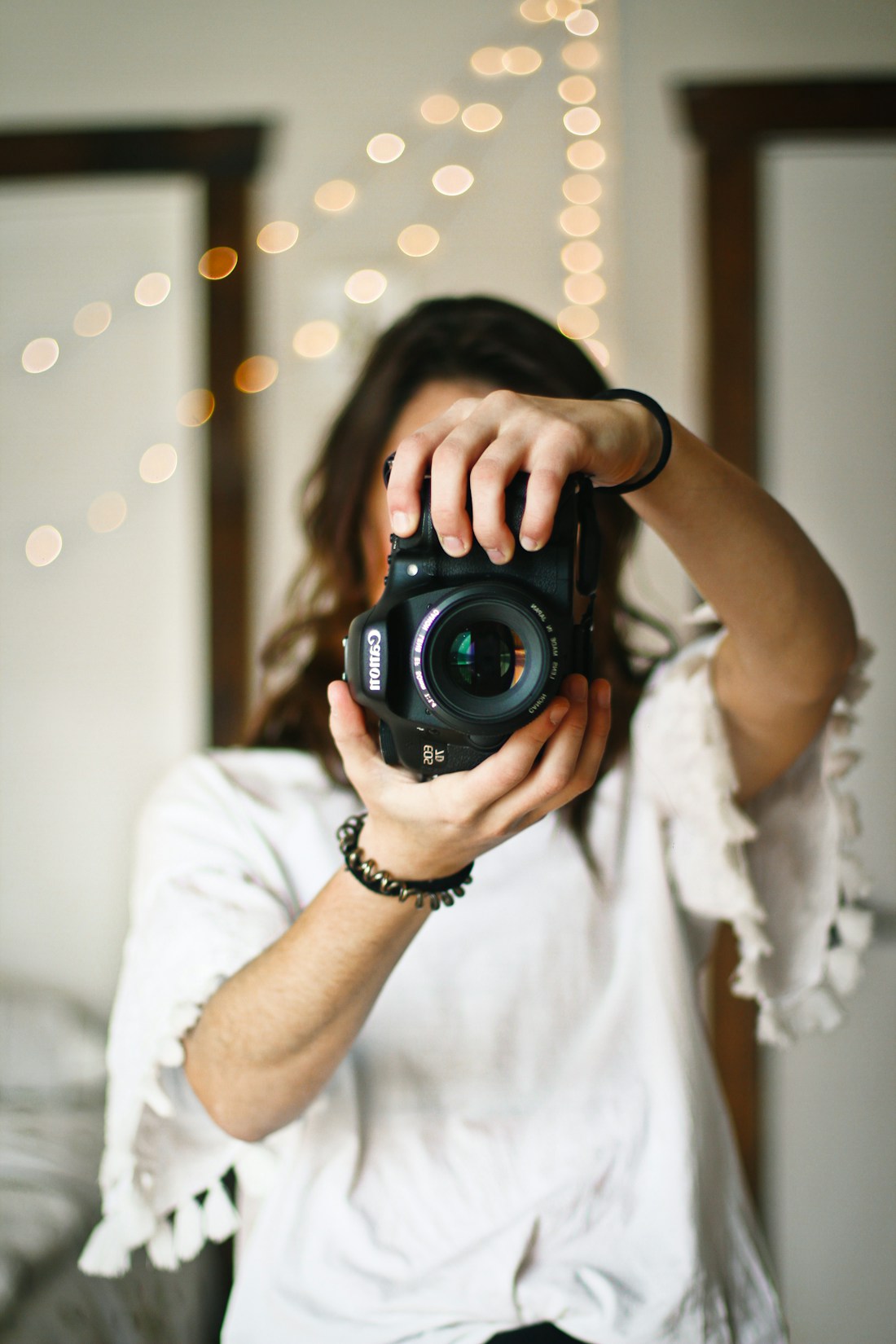 A photographer holding her camera in natural light